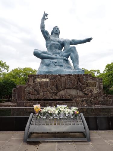 The Peace Statue at Nagasaki. The elevated right hand points to the threat of nuclear weapons, while the outstretched left hand symbolises tranquility and world peace